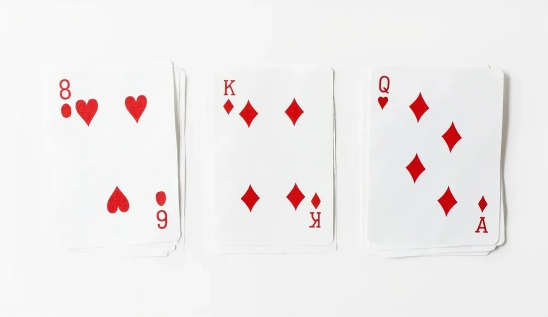 Three valid rummy melds laid out on a single sheet of white paper
